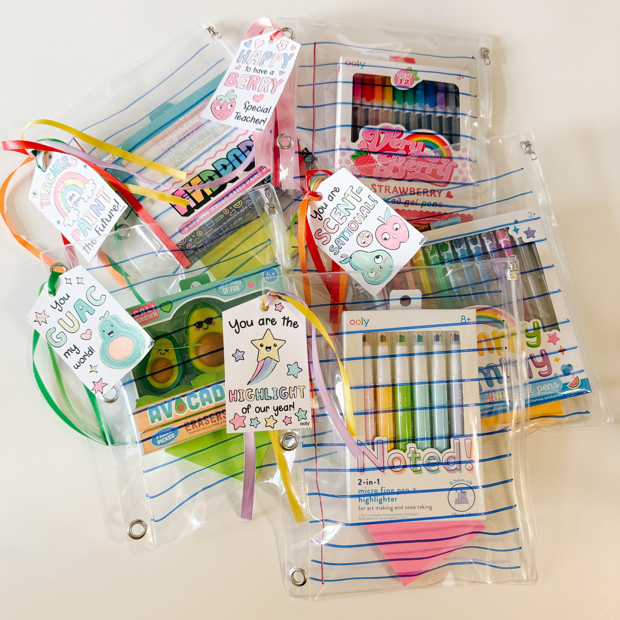 A group of Teacher appreciation gifts various OOLY products markers highlighters gel pens in a gift pack with a printable coloring gift tag