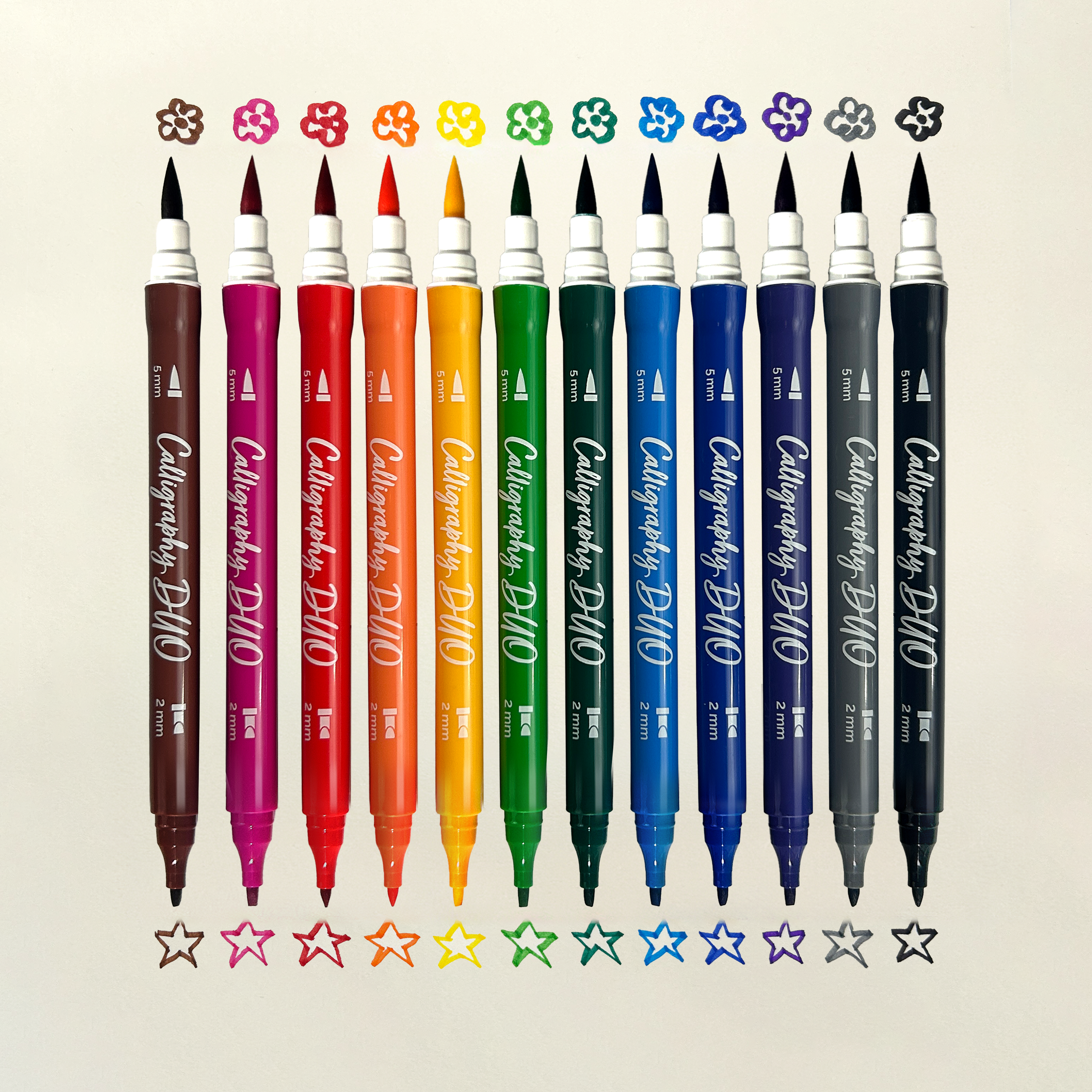 Row of OOLY Calligraphy Duo Double-Ended Markers with chisel and brush tip swatches