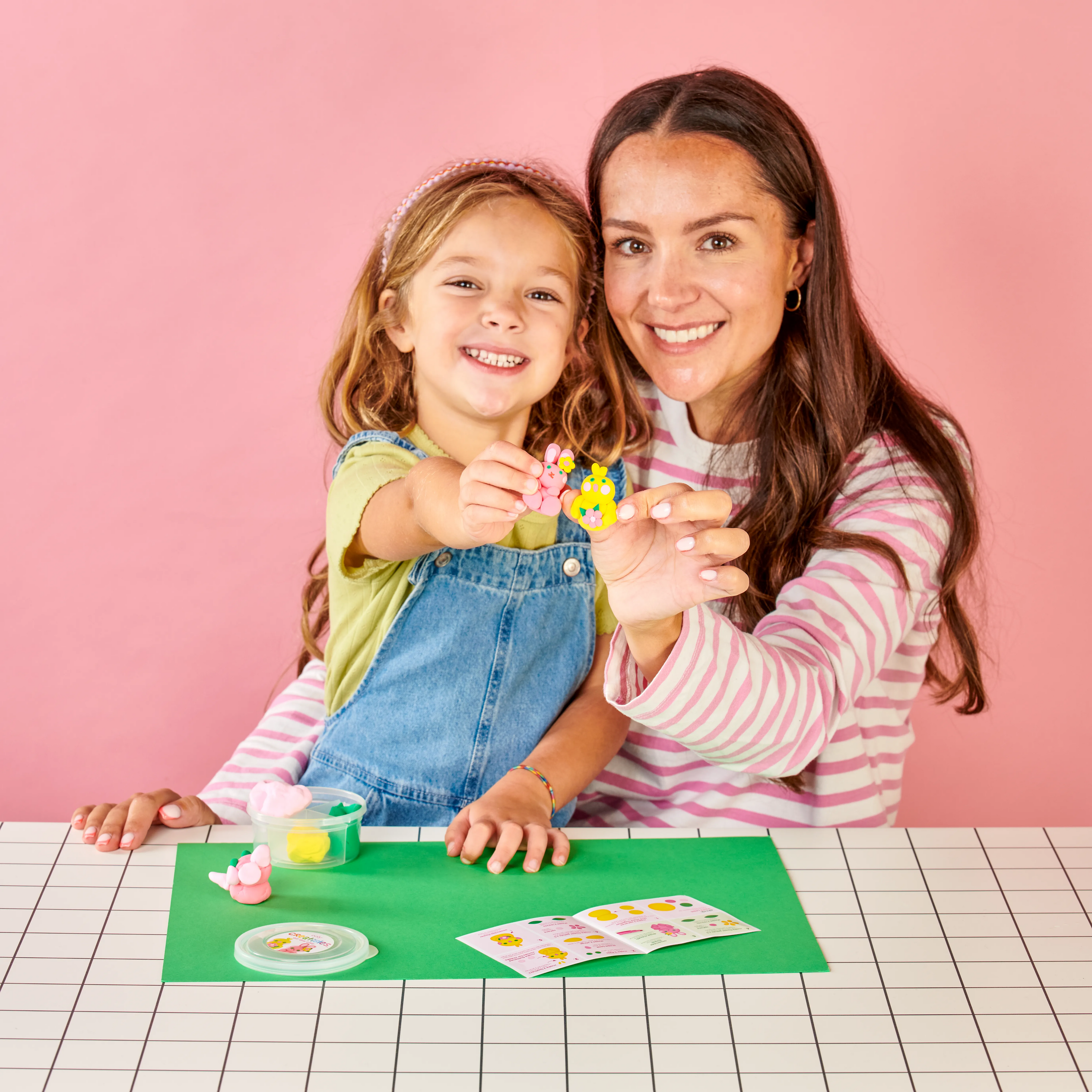 Mom and daughter holding up completed bunny and chick from Creatibles Mini Air Dry Clay Kit - Garden Pals BFFs