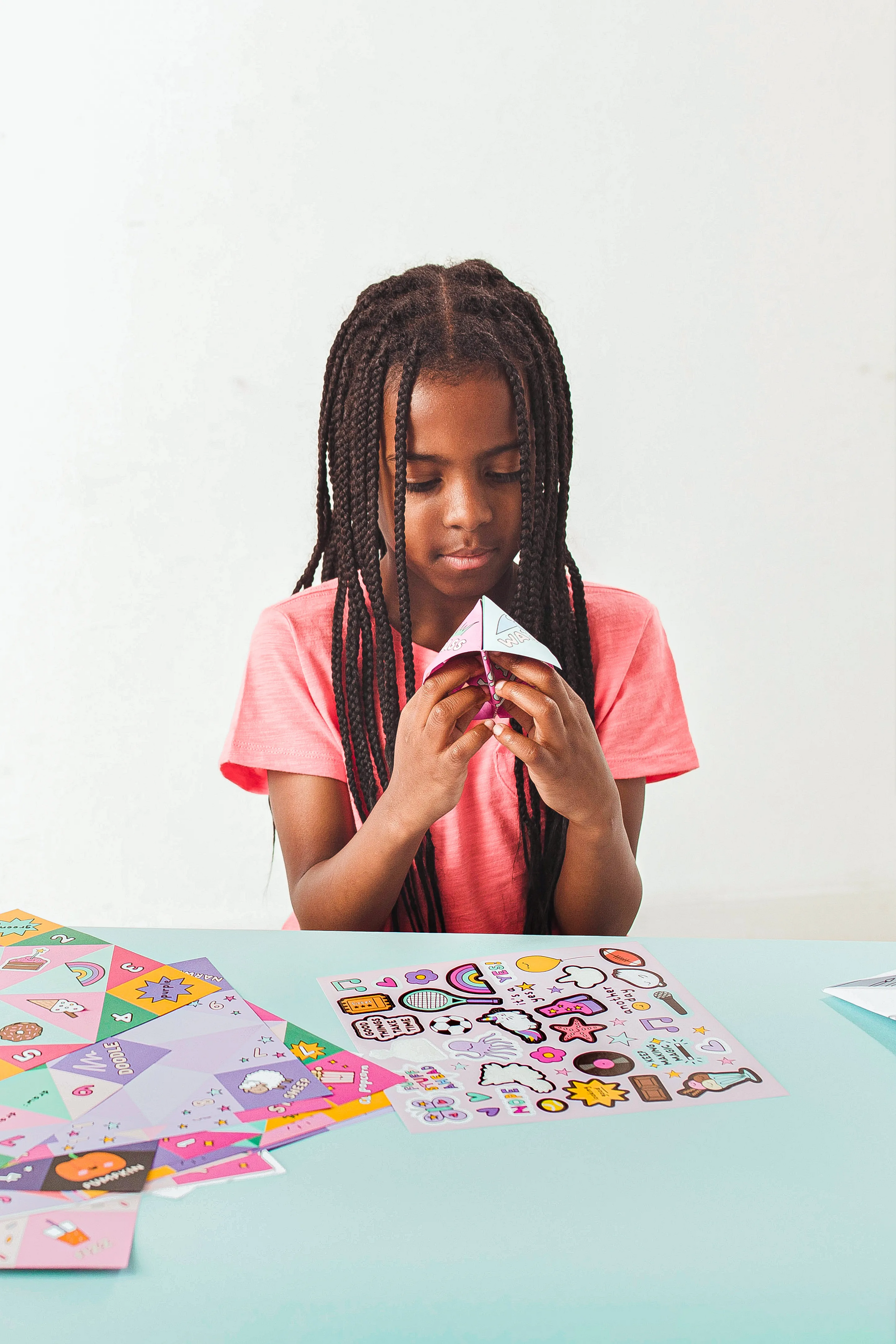 Girl playing with finished OOLY DIY Fortune Teller