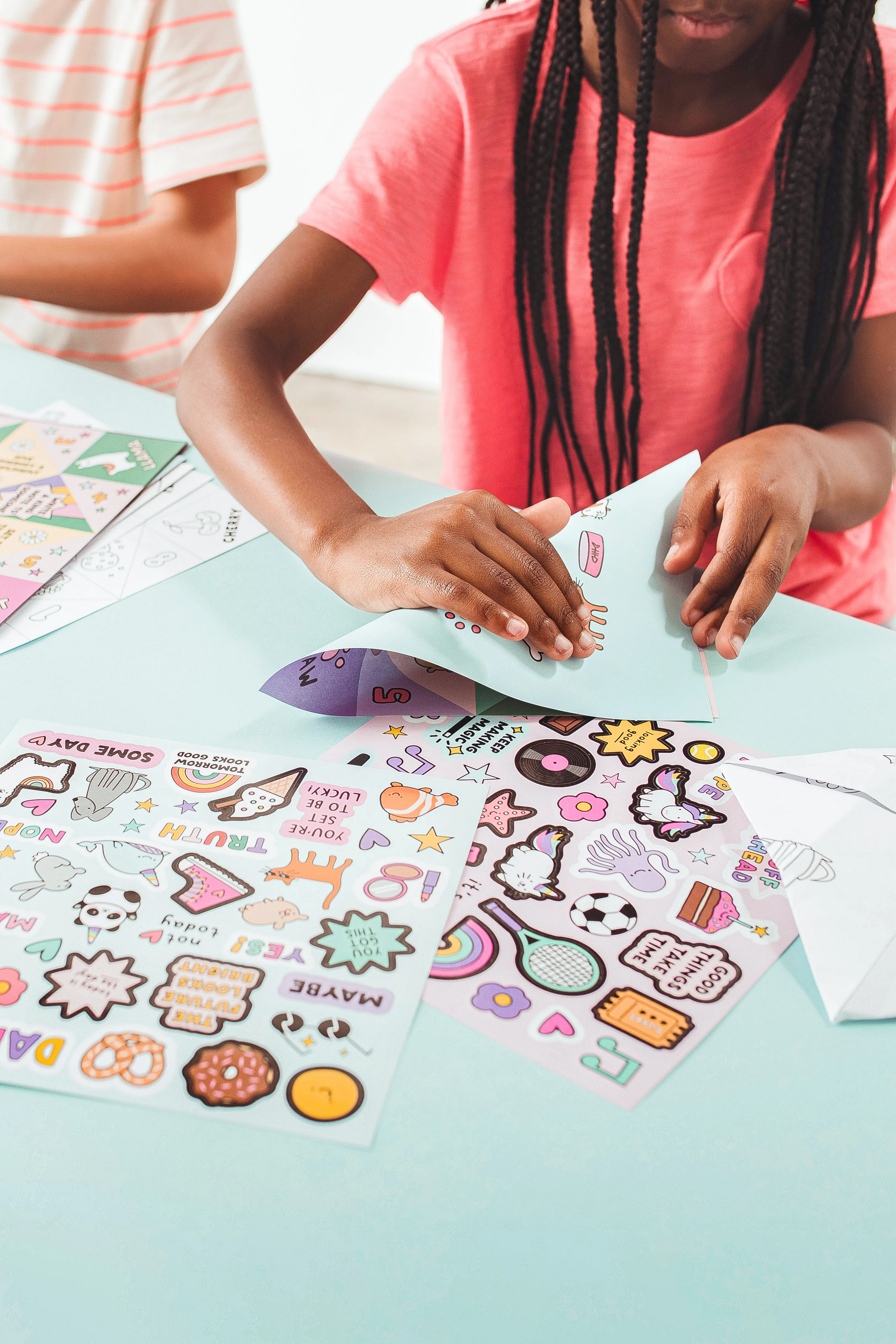 Kid folding fortune teller from OOLY DIY Fortune Tellers Activity Kit