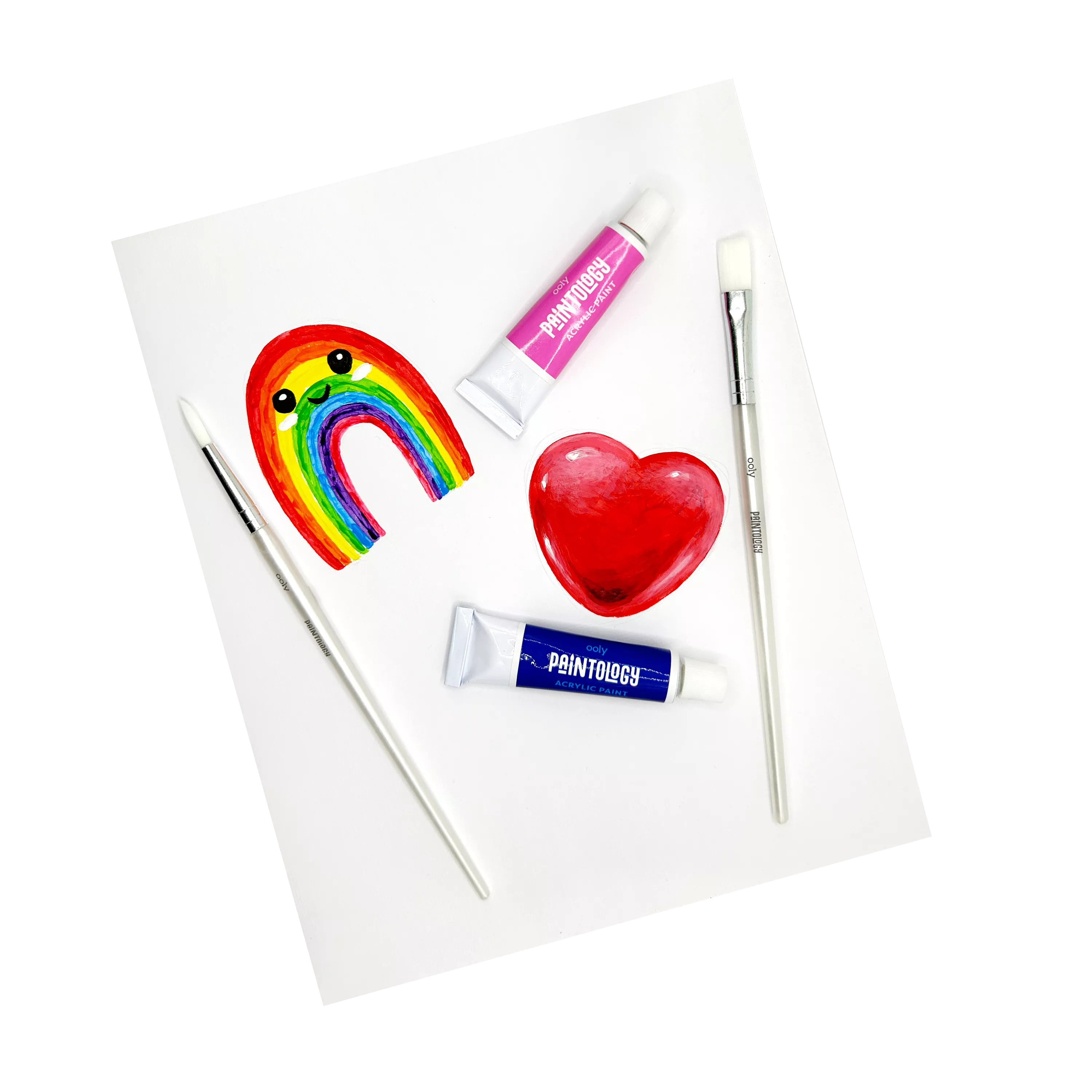 Happy rainbow and heart paintings on paper with paintbrushes and tubes from OOLY Paintology Acrylic Paint Set - Classic Colors