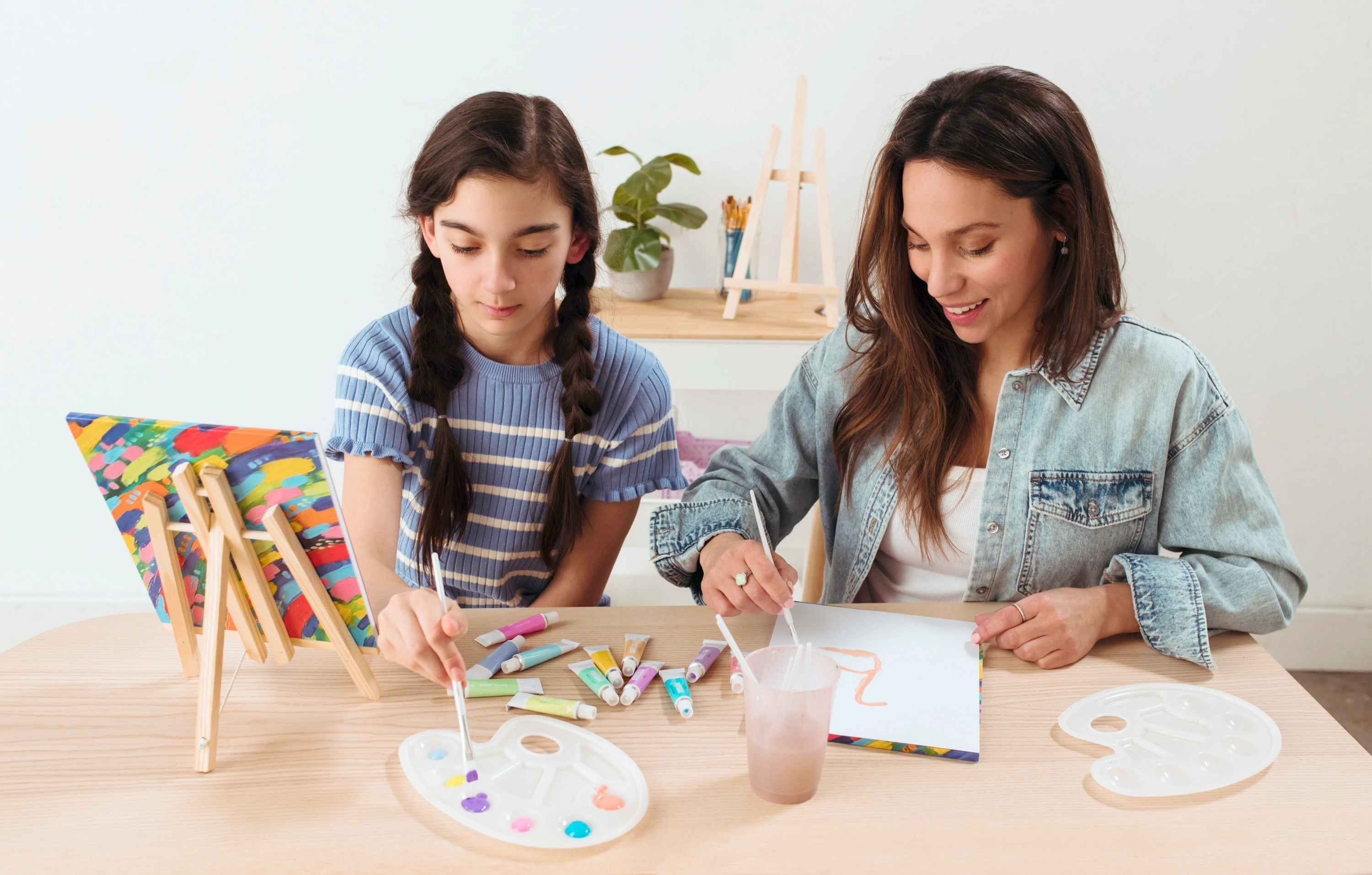 Woman and girl painting with paintbrushes in painting setting with OOLY Paintology Acrylic Paint Set - Pastel Colors