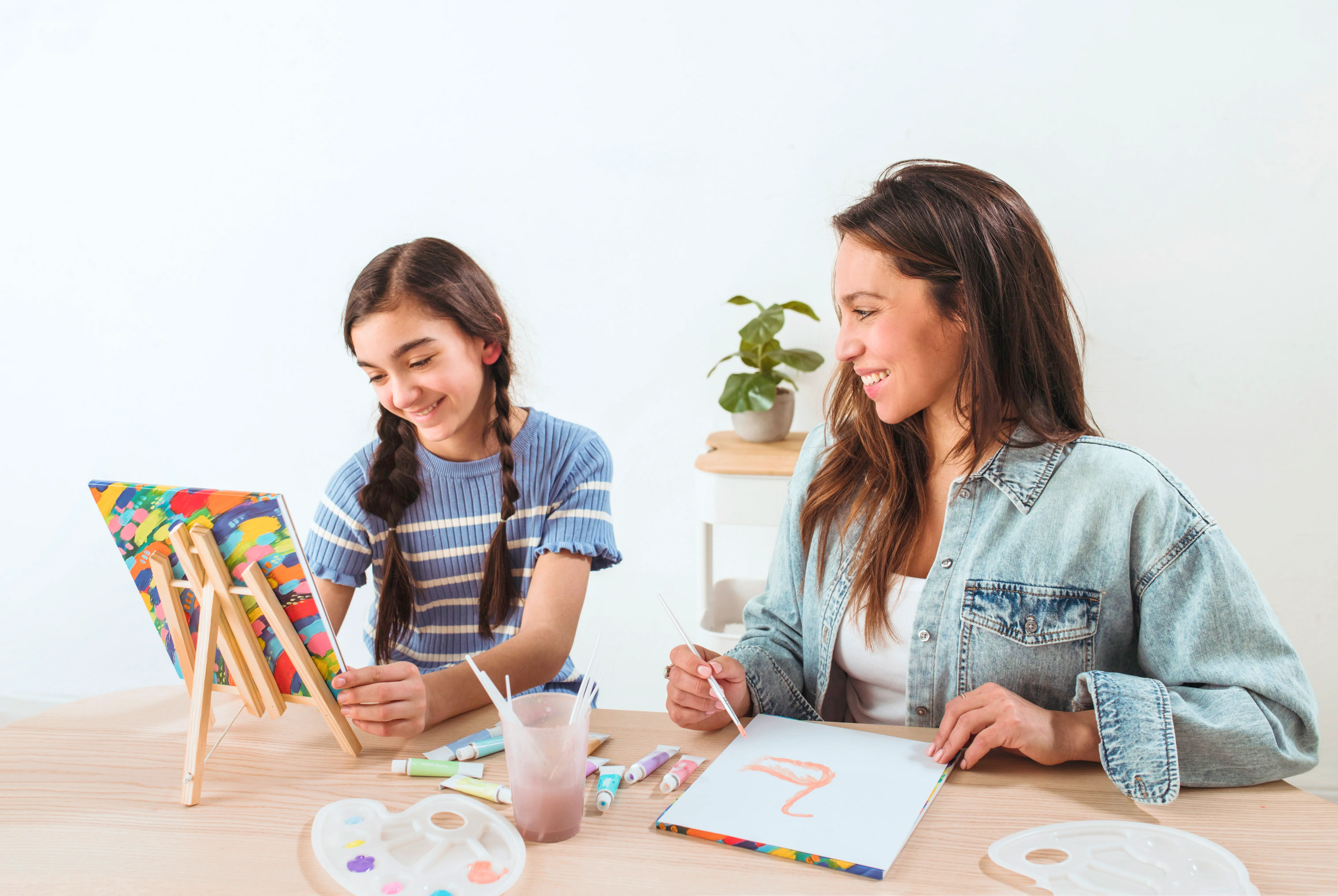 Girl and woman painting with paintbrushes in painting setting with OOLY Paintology Acrylic Paint Set - Pastel Colors