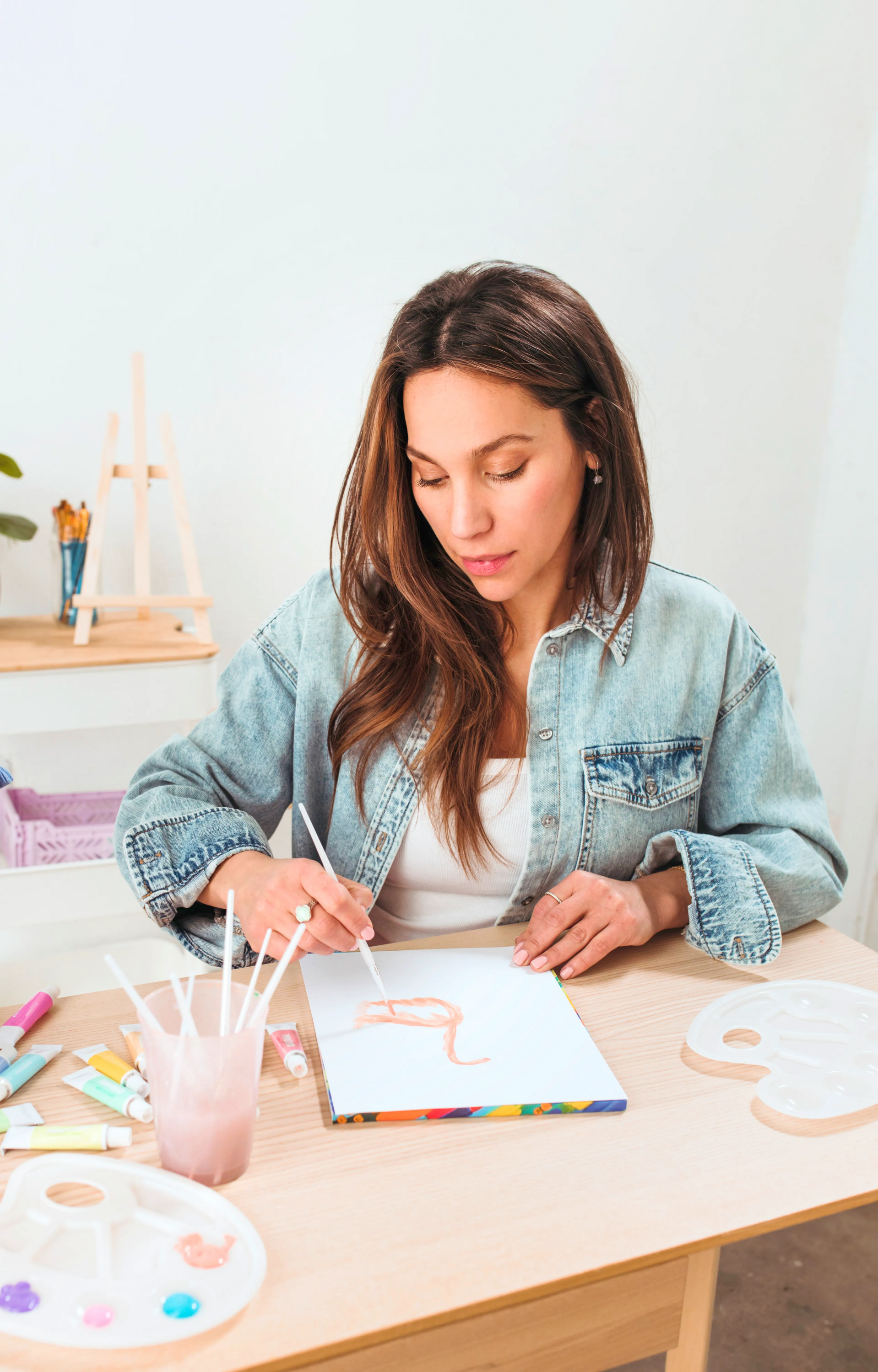 Woman and painting with paintbrushes in painting setting with OOLY Paintology Acrylic Paint Set - Pastel Colors