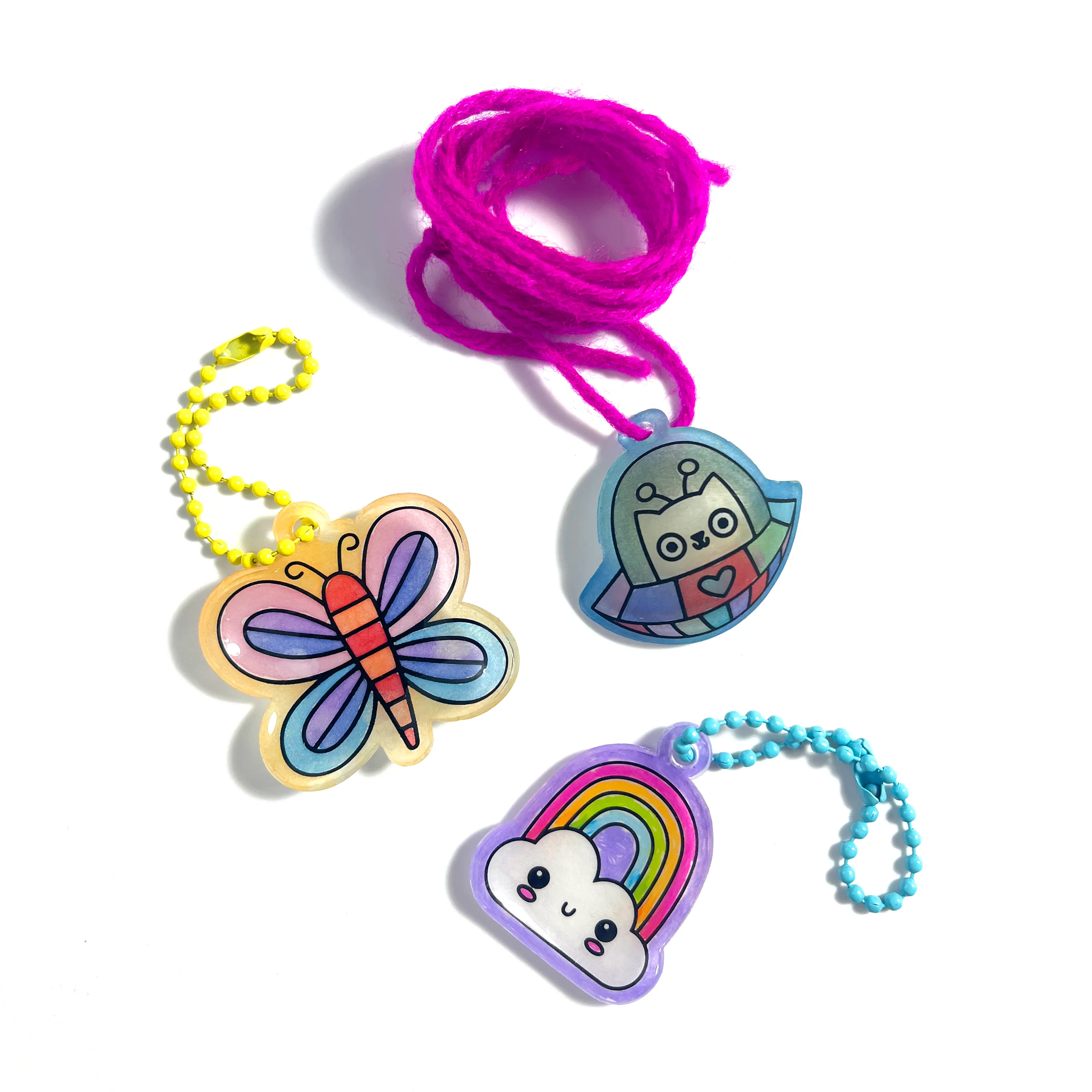 Completed charms from the OOLY Shrink-its! DIY Shrink Art Kit - Cute Crew set including butterfly, space cat and rainbow